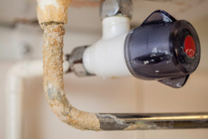 Hard water plumbing damage on a boiler pipe
