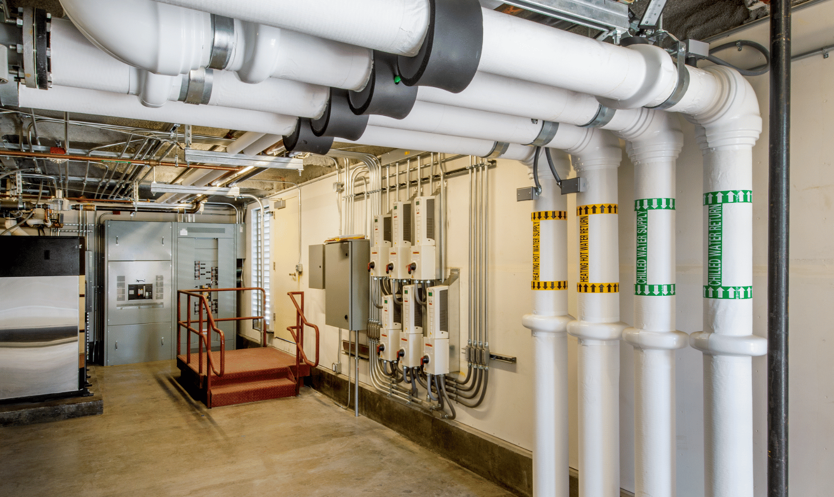 Industrial chilled water piping and control equipment illustrating a closed loop system, feedback control, control loops, and automated temperature control in an industrial facility.