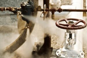 Steam release from a high pressure boiler valve in an industrial steam pressure system. High-temperature piping, saturated steam, and psi-rated components support safe operation in high pressure steam systems.