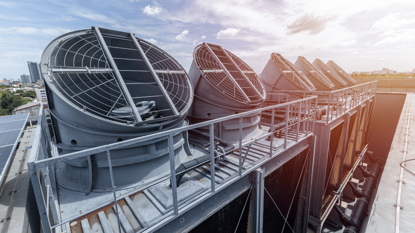 Industrial cooling tower with large fans, piping, and equipment used to manage makeup water, evaporation, heat, filtration, and water treatment in a plant.