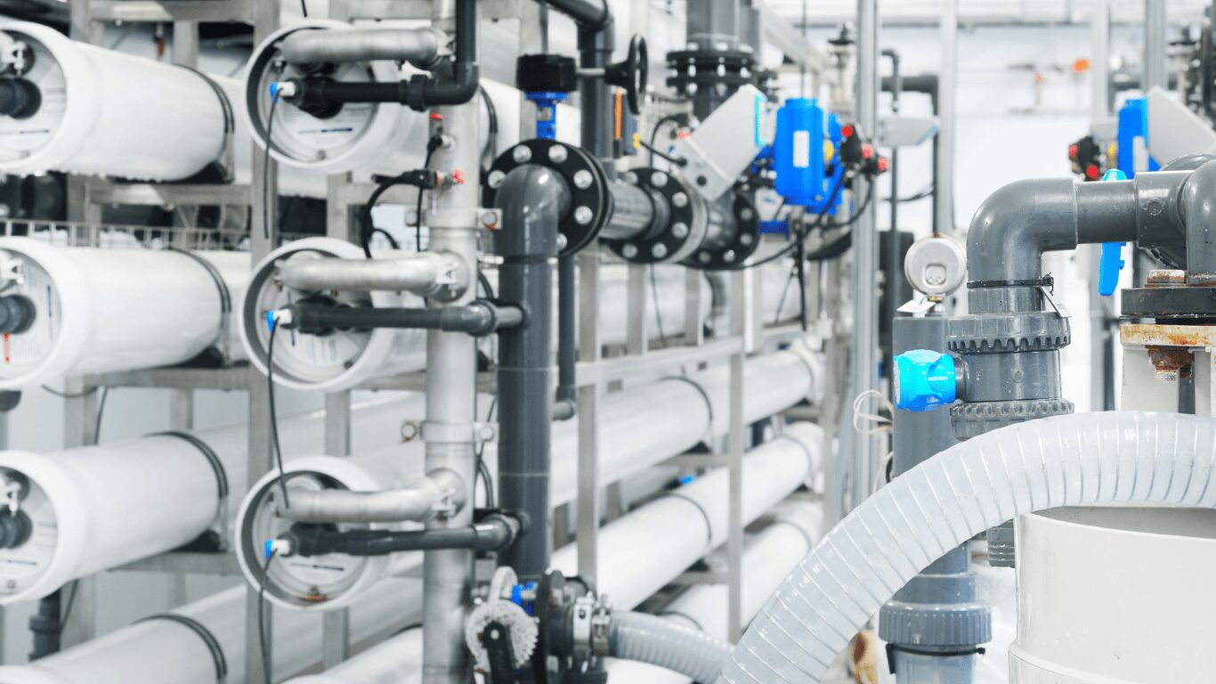 Industrial reverse osmosis water treatment system showing multiple membrane filters and piping used as a chemical-free treatment method to remove hydrogen sulfide, salt, bacteria, lead, arsenic, chlorine, organic compounds, and pesticides. This system demonstrates how reverse osmosis removes contaminants through tiny pores, providing clean, fresh water for whole home use, food preparation, and family faucets. Such treated water systems reduce odor and acid content, protect those exposed to contaminants, and improve taste without adding chemicals. Designed for easy installation and powered by electricity, these systems save water, air, and energy while offering a reliable example of sustainable water purification. Reverse osmosis units like this treat and pass water through membranes with the ability to achieve high contaminant reduction, ensuring safe, fresh, and clean water for home or industrial applications.