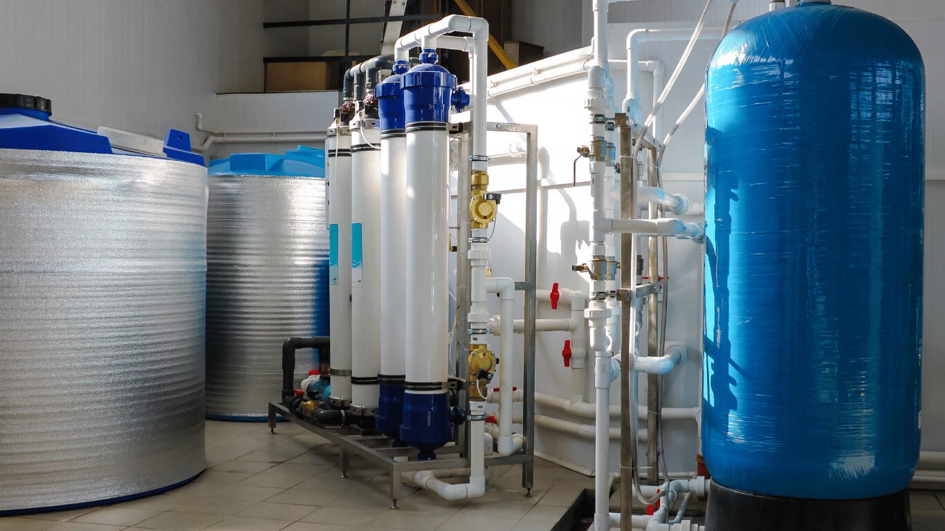 Industrial membrane filtration equipment with pressure vessels, tanks, and piping used in water treatment, drinking water treatment, and advanced filtration systems for the food and beverage industry. The image represents different types of membrane filtration, including reverse osmosis, ultrafiltration uf, and nanofiltration nf, which use a semi permeable membrane and specialized membrane filters to remove particles, suspended solids, suspended substances, and larger particles during the filtration process. These membrane filtration systems support water purification, wastewater treatment, water desalination, and industrial filtration operations by using engineered membrane material such as cellulose acetate, cellulose nitrate, and polyvinylidene fluoride. The setup also illustrates reverse osmosis ro systems with high-performance ro membranes and reverse osmosis membranes designed to filter dissolved salts, dissolved ions, heavy metals, small ions, and organic compounds from feed liquid streams in industrial processes and industrial applications.