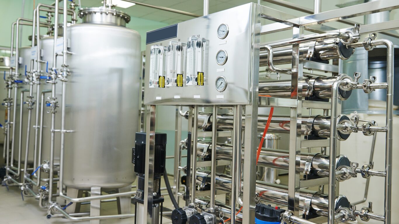Industrial water treatment system with reverse osmosis, water filtration, softening systems, and boiler equipment installed inside a modern hospital facility. Stainless steel systems help produce high purity water by removing contaminants, including calcium, magnesium ions, and calcium and magnesium ions, reducing hard water, scale, chlorine, chemicals, pollutants, and pesticides from water sources. The water treatment process supports water quality, clean water, sterile water, medical devices, operating rooms, patient care areas, patient safety, and healthcare settings while meeting stringent safety standards and industry standards.