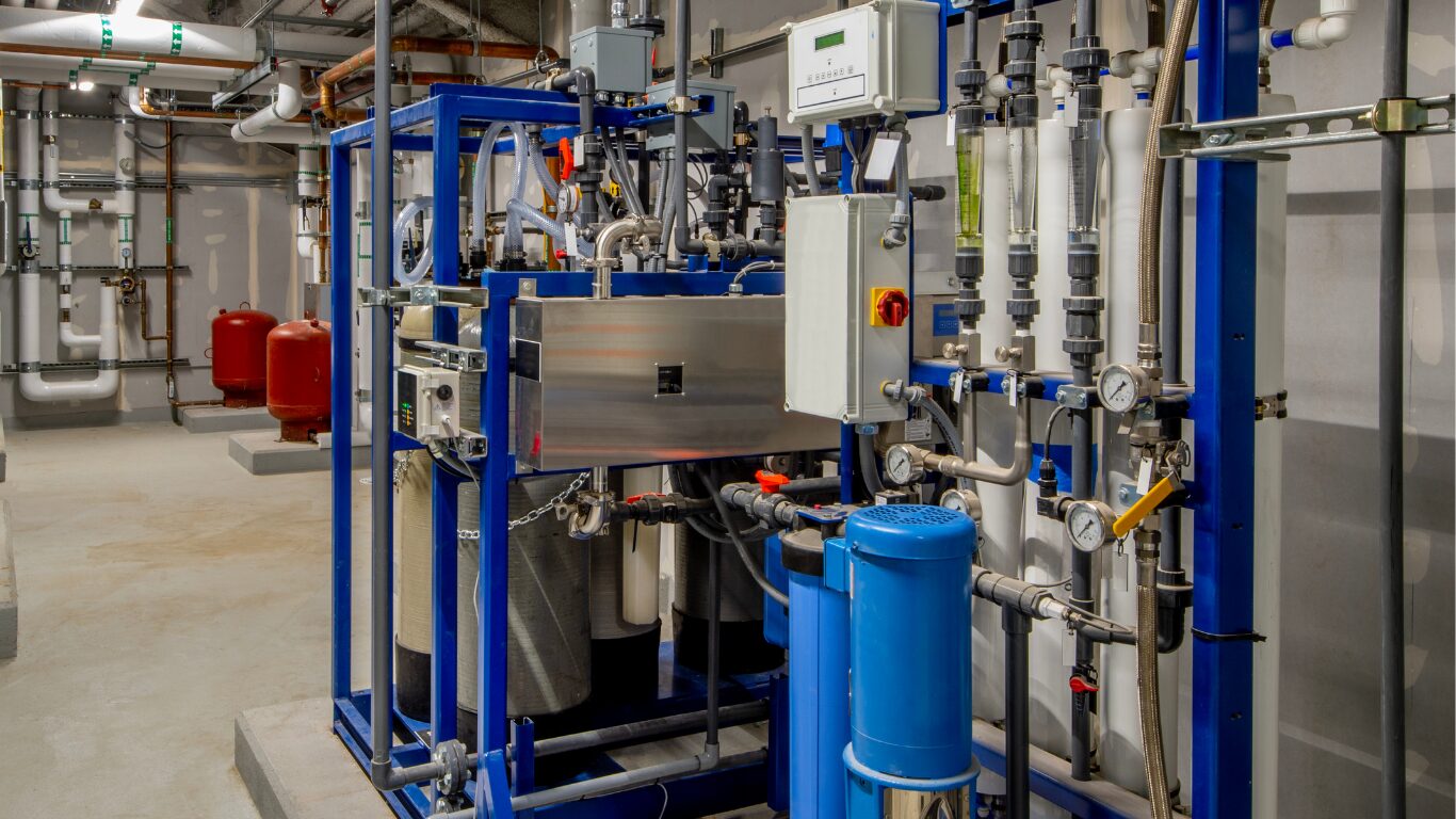 Industrial water treatment system with pumps, filtration units, piping, and chemical dosing equipment used to apply oxidizing biocides and non oxidizing biocides for microbial control in water systems, cooling towers, and other industrial water systems.