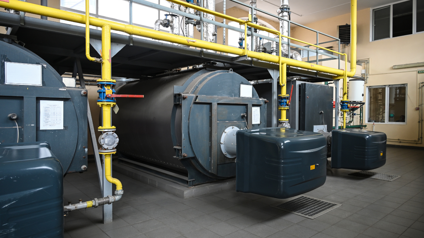 Industrial boiler system with boiler tubes, pipes, and equipment for scale removal and water treatment.