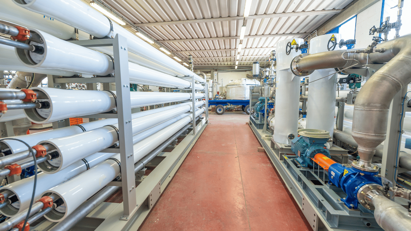 Industrial water treatment system with large filtration equipment, pumps, pipes, and reverse osmosis systems for commercial properties in Sarasota, FL.